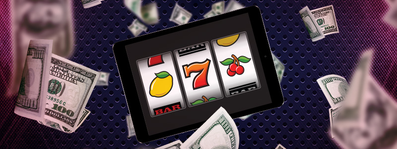 a tablet with an online slots surrounded by falling dollars
